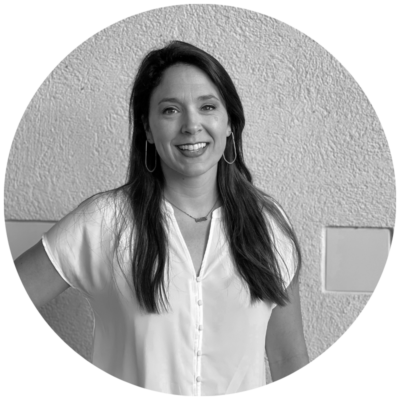 Tess Frear Headshot (Black & White) on a white stucco wall 